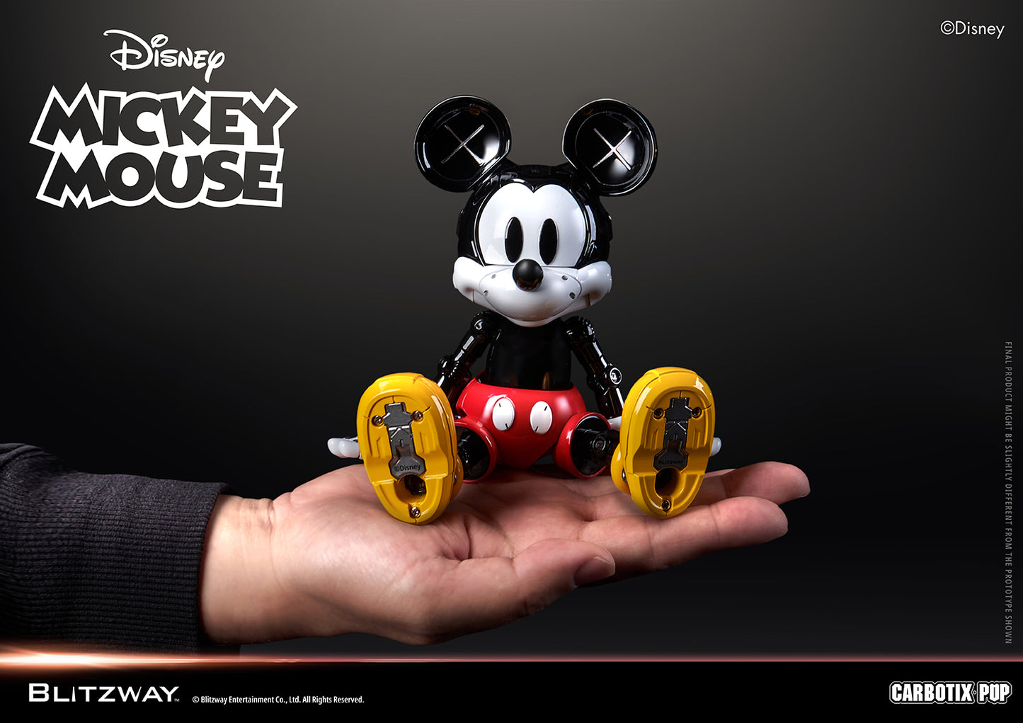 Blitzway Carbotix Pup Disney Mickey Mouse articulated action figure sitting on a human hand, showing the compact collectible size with detailed yellow shoe undersides against a dark background