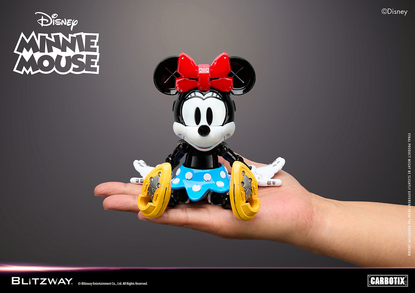 Blitzway Carbotix Disney Minnie Mouse articulated action figure sitting on a human hand, showing the compact collectible size with red bow, blue polka-dot skirt, and detailed yellow shoe undersides